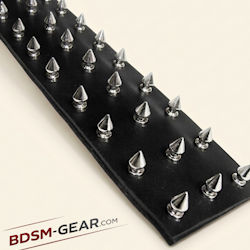 spiked bdsm paddle for impact play with textured leather surface

